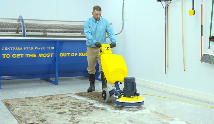 Professional rug cleaning using equipment